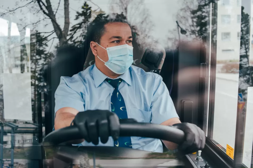 Bus driver wearing a COVID-19 protective mask